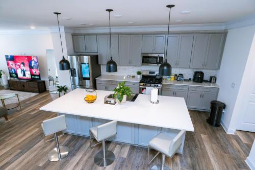 a kitchen with a large white island in the middle at Ensuite King bedroom in Charlotte