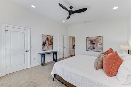a bedroom with a bed with a ceiling fan at Anna Maria Island Beach Palace in Bradenton Beach