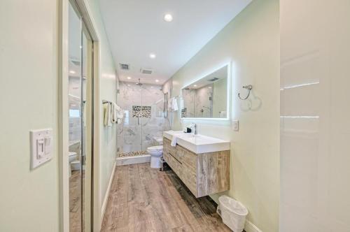 a white bathroom with a sink and a shower at Anna Maria Island Beach Palms 5B in Bradenton Beach