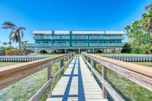 a building on a boardwalk in front of a building at Anna Maria Island Beach Palms 5B in Bradenton Beach