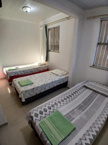 a room with two beds in a room at Brisa Tropical in Ilhéus