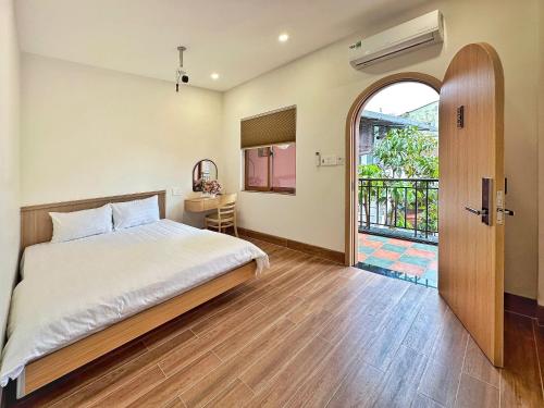 a bedroom with a bed and an open door at DEE Homestay in Hue