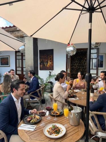 a group of people sitting at a table in a restaurant at Casa Bravo in Toluca