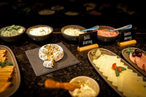 a table topped with different types of food on plates at The Cloud One Hamburg-Kontorhaus in Hamburg