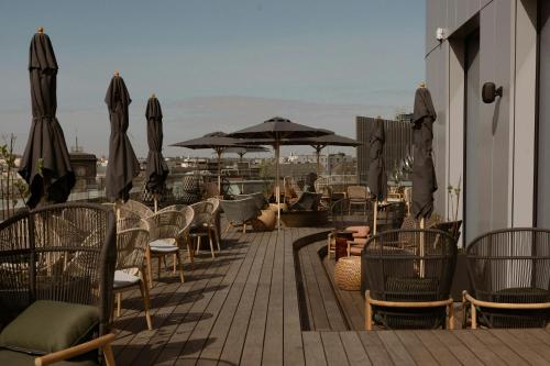 a patio with chairs and umbrellas on a building at The Cloud One Prague in Prague
