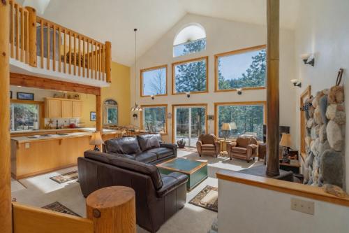a living room with a couch and a table at Pine Tree Cottage by NW Comfy Cabins in Leavenworth