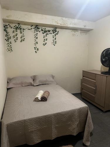 a bedroom with a bed with two shoes on it at 3R acomodações in Juazeiro do Norte
