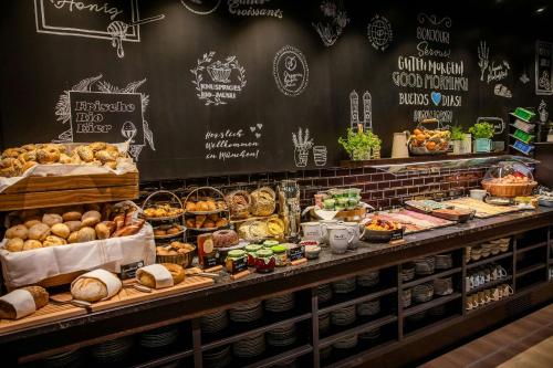 a bakery with many different types of bread and pastries at Motel One München-Hauptbahnhof in Munich