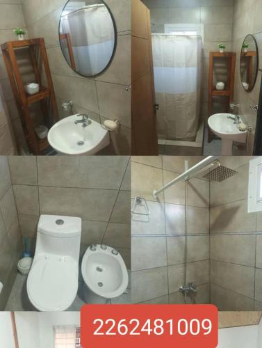 a bathroom with a toilet and a sink and a mirror at Cabaña in Necochea