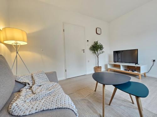a living room with a couch and a table at Elroi Suite in Minden