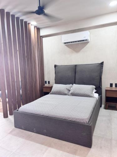 a bedroom with a bed and a air conditioner at Xiib Kaab Estudio con Jacuzzi in Tulum