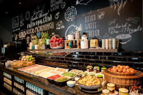 a buffet of food on a table in a restaurant at Motel One Graz in Graz