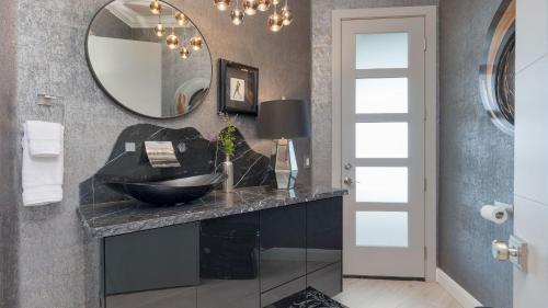 a bathroom with a sink and a mirror at Summit Ranch by AvantStay in Temecula