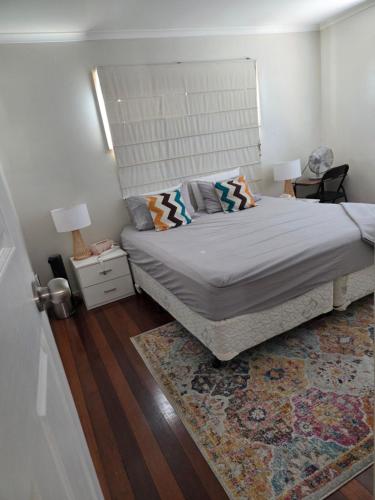 a bedroom with a bed and a rug at BR Rooms in a Shared house in Kingston