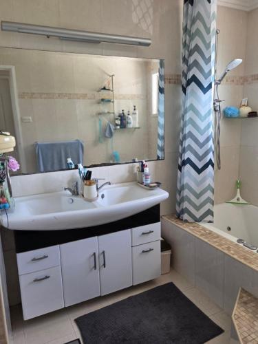 a bathroom with a sink and a mirror and a shower at BR Rooms in a Shared house in Kingston