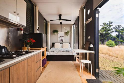 a tiny house with a bed in the middle at The Ridge by Tiny Away in Korweinguboora