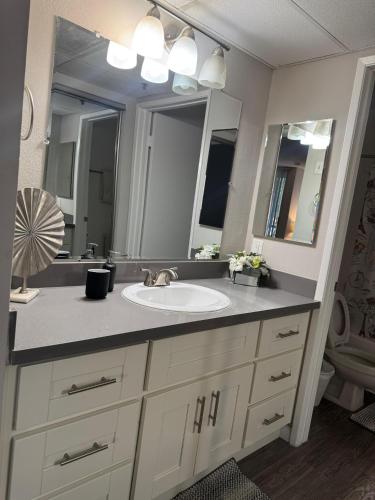 a bathroom with a sink and a large mirror at Loft Hollywood apartments FREE Parking and Central Location in Los Angeles