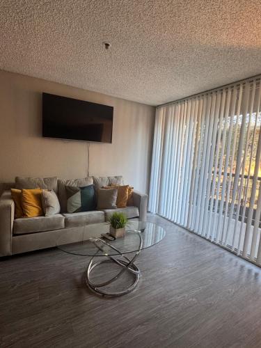 a living room with a couch and a glass table at Loft Hollywood apartments FREE Parking and Central Location in Los Angeles
