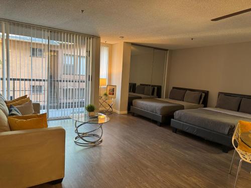 a living room with two beds and a couch at Loft Hollywood apartments FREE Parking and Central Location in Los Angeles