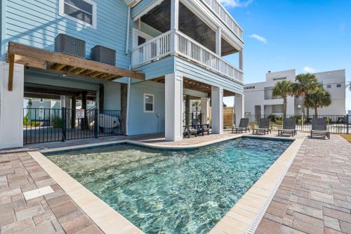 a house with a swimming pool in front of it at Blue Horizon at Pensacola Beach - Heated Pool, Across beach access, Beach gear, Dogs OK! in Pensacola Beach