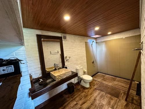 a bathroom with a sink and a toilet at Munduk V View House in Munduk