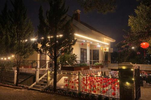 a house with lights on the front of it at night at Umee Stayin Đà Lạt in Da Thanh