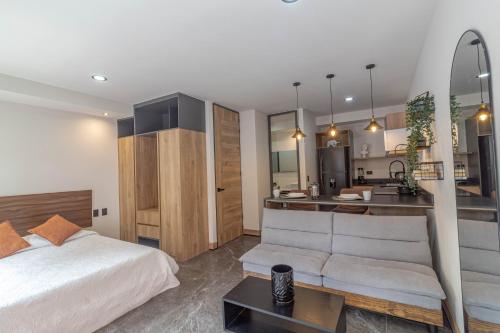 a bedroom with a bed and a sink and a kitchen at LOFT en Americana Torre con alberca, Gym, 103 in Guadalajara