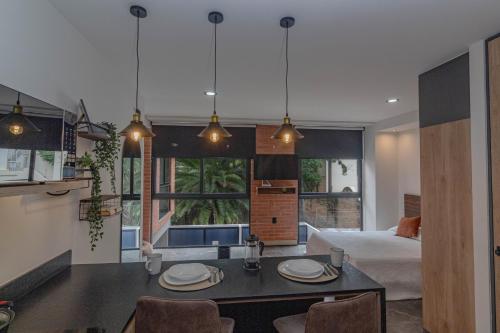 a room with a bed and a table with chairs at LOFT en Americana Torre con alberca, Gym, 103 in Guadalajara