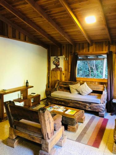 a bedroom with two beds in a room with logs at Logia Blanca in Villarrica