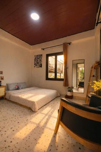 a bedroom with a large bed and a window at Umee Stayin Đà Lạt in Da Thanh