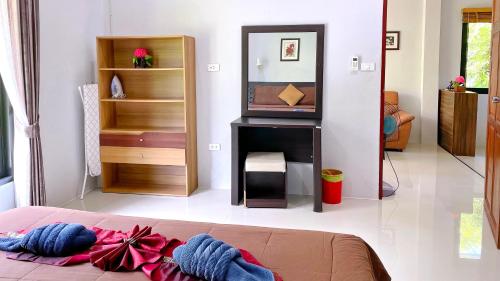 a living room with a bed and a television at Abbas House by Swiss Chalet, 2-room Cottages in Krabi