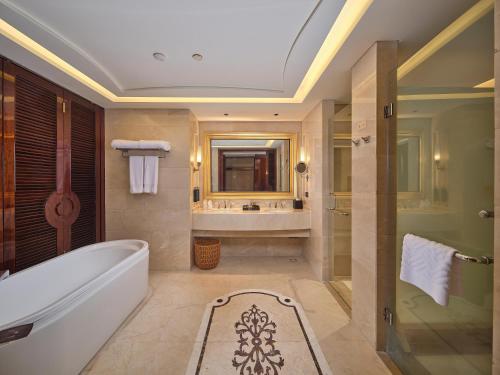 a bathroom with a tub and a sink at Doubletree By Hilton Sanya Bay in Sanya