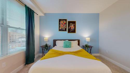 a bedroom with a large bed with blue walls and a window at Stylish Home With Free ParkingZA in Stamford
