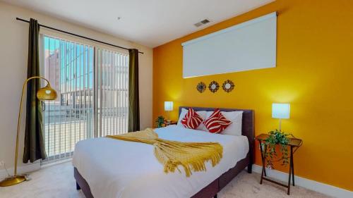 a bedroom with a large bed and a large window at Stylish Home and Cozy200 in Stamford