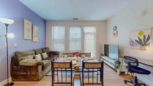 a living room with a couch and a table with chairs at Stylish Home and Cozy in Stamford
