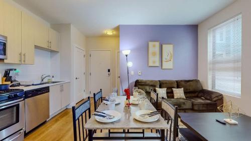 a kitchen and living room with a table and a couch at Stylish Home and Cozy in Stamford