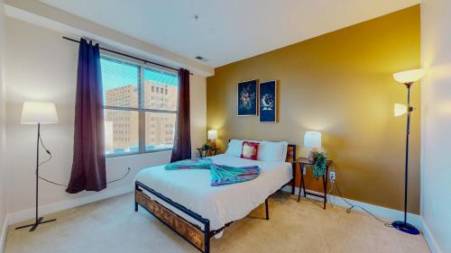 a bedroom with a bed and a large window at Great Charming stay in Stamford