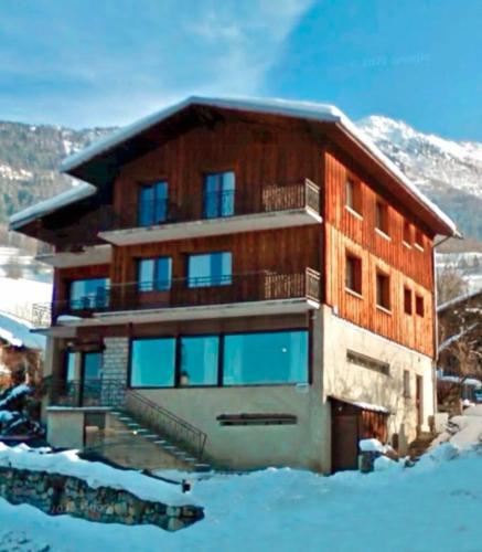 a large building with snow in front of it at Former Hotel Transformed Into Chalet In Valmorel in Les Avanchers