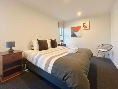 a bedroom with a bed and a table and a chair at Star View in Lake Tekapo