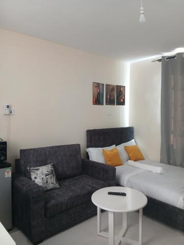 a living room with a couch and a coffee table at Machakos Town Studios in Machakos