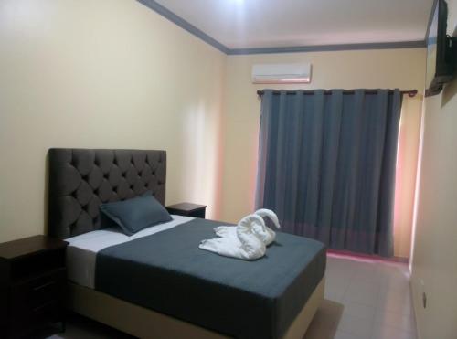 Llit o llits en una habitació de ApartHotel Redentor