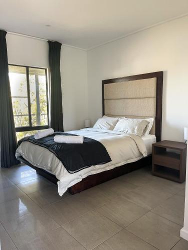 a bedroom with a large bed and a window at Stunning Cable Beach - Unit in Cable Beach