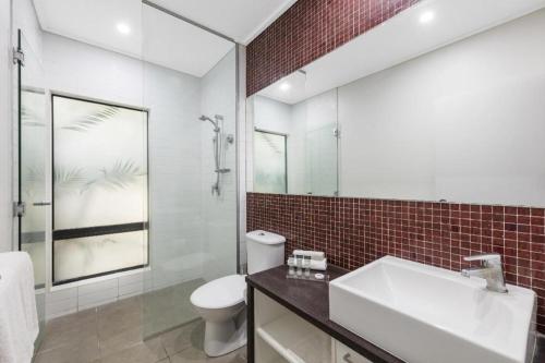 a bathroom with a white sink and a toilet at Stunning Cable Beach - Unit in Cable Beach
