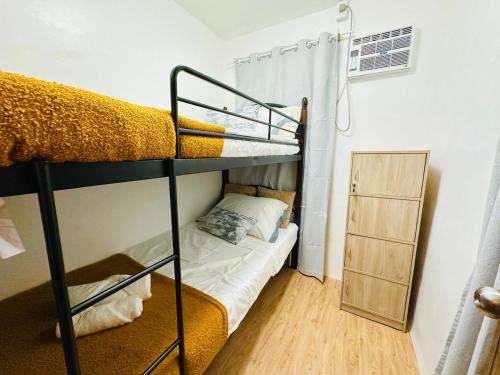a bedroom with a bunk bed in a room at Casa Del Sol! 2BR Puerto Princesa in Puerto Princesa City
