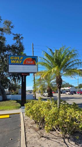 a sun way sign next to a palm tree at Gulf Way Inn Clearwater in Clearwater