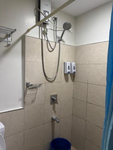 a shower with a shower head in a bathroom at Jo Condotels at Persimmon Tower3 in Cebu City