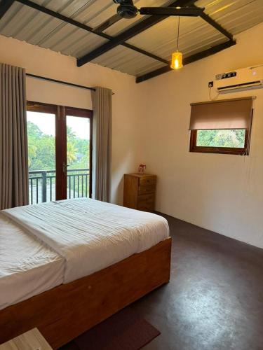 a bedroom with a bed and a balcony at Mount Boutique Villa in Kandy