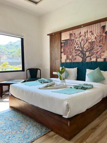 a bedroom with a large bed with a wooden headboard at Orchard Hills Resorts in Pushkar