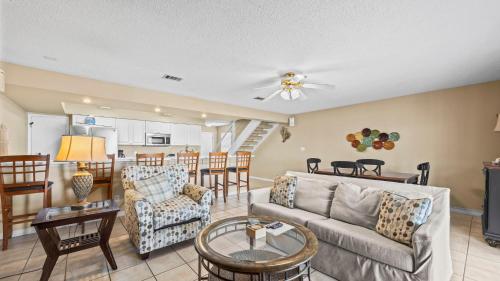 a living room with a couch and a table at Sixty-Five & Salty Bay View 65 in Orange Beach