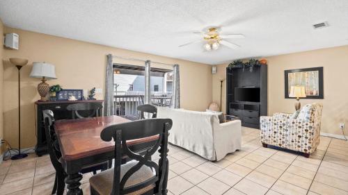 a living room with a table and a couch at Sixty-Five & Salty Bay View 65 in Orange Beach